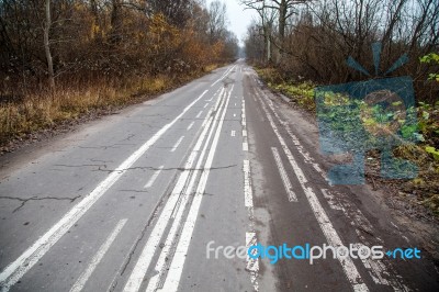 Old Abandoned Asphalt Road With Spoiled Road Markings Stock Photo