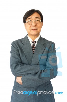 Old Aged Thai Businessman With Glasses Is Standing And Looking Stock Photo