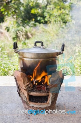 Old Aluminium Pot On Stove With Fire And Smoke, Folk Cooking Way… Stock Photo