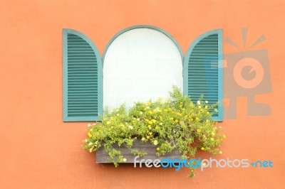 Old Arched Green Window Opened On Orange Wall Stock Photo