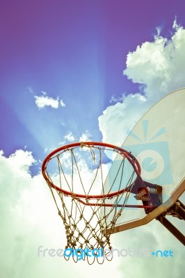 Old Basketball Board And Hoop On Blue Sky With Clouds Background… Stock Photo