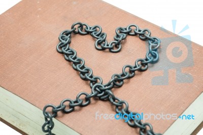 Old Book With Chain In The Shape Of A Heart Isolated On White Ba… Stock Photo