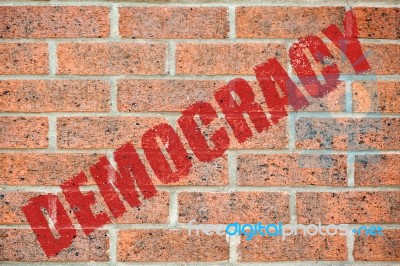 Old Brick Wall Texture With Democracy Inscription Stock Photo