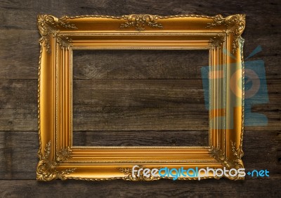 Old Brown Picture Frame On Wooden Background Stock Photo