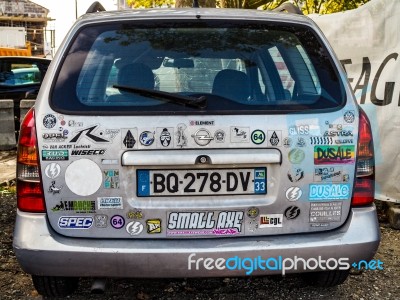 Old Car In Bordeaux Covered In A Multitude Of Stickers Stock Photo