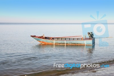 Old Fisher Boat With Engine Near Beach Stock Photo