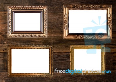 Old Gold Picture Frames On Wooden Wall Stock Photo