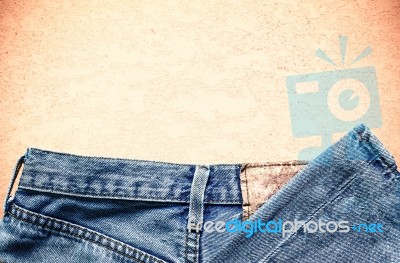 Old Jeans On Concrete Stock Photo