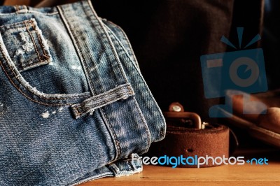 Old Jeans On Wooden Stock Photo