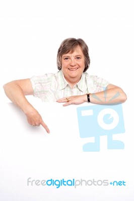 Old Lady Pointing At Blank Board Stock Photo