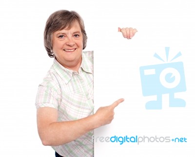 Old Lady Pointing At Blank Board Stock Photo