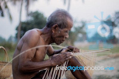 Old Man Are Weaving In Countryside Stock Photo