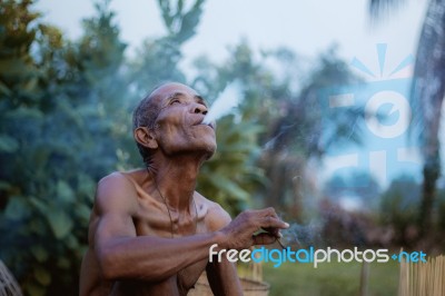 Old Man Smokes Cigarettes Stock Photo