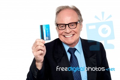 Old Man Wearing Eyeglasses Holding Up A Cash Card Stock Photo