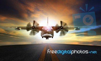 Old Military Plane Approaching To Landing On Airport Runway Stock Photo