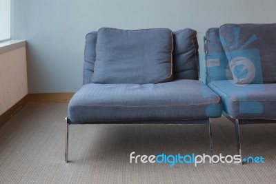 Old Modern Blue Chair On Dirty Carpet Floor Stock Photo