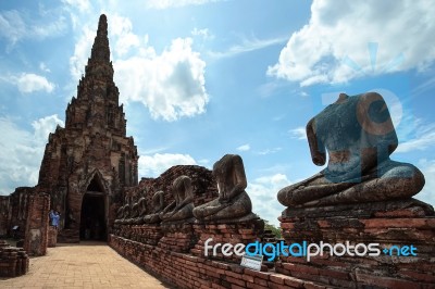 Old Pagoda And Ruined Buddha Statue In Chaiwatthanaram Temple Stock Photo