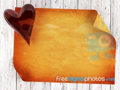 Old Paper On Wood Background With Red Glass Heart Stock Image