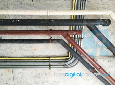 Old Pipes Line On Cement Wall Stock Photo