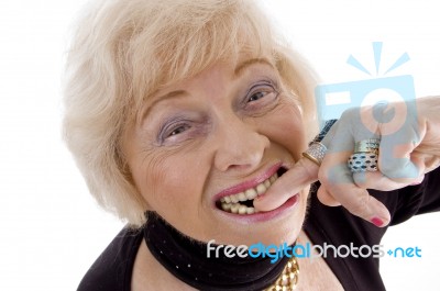 Old Woman With Finger In Her Mouth Stock Photo