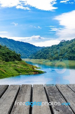 Old Wood Table In Front Of The Lake Stock Photo