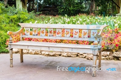 Old Wooden Bench In Beautiful Garden Background Stock Photo