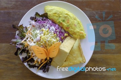 Omelet With Mix Salad And Thick Bread In White Plate Stock Photo