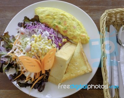 Omelet With Mix Vegetable Salad And Thick Bread Breakfast Stock Photo