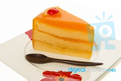 One Piece Of Orange Cake With Wooden Small Spoon Stock Photo