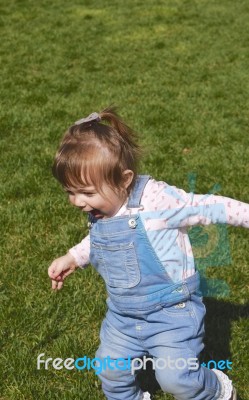 One Year Old Running On Grass Stock Photo