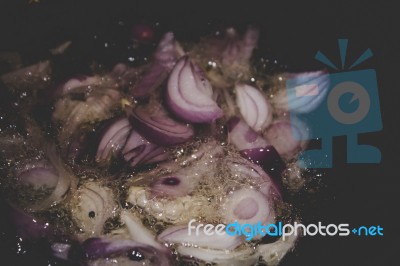 Onions Cooking In Oil Background Stock Photo