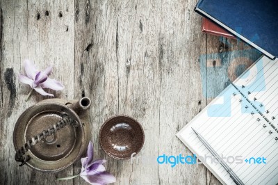 Open Notebook And Pen With Teapot On Old Wooden Background Stock Photo