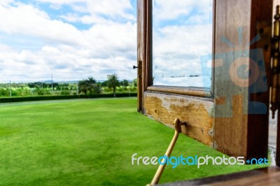 Opened Wooden Windows For Green Field And Sky Stock Photo