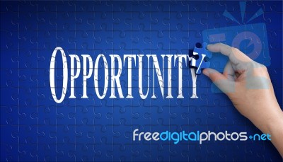 Opportunity Word On Jigsaw Puzzle. Man Hand Holding A Blue Puzzl… Stock Photo