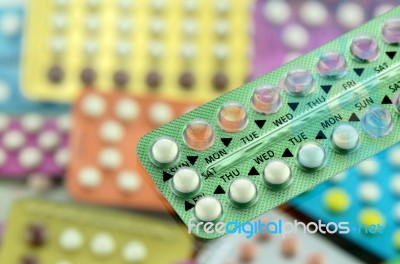 Oral Contraceptive Pill On Pharmacy Counter With Colorful Pills Stock Photo