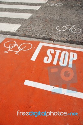 Orange Bicycle Lane With A Stop Sign Stock Photo