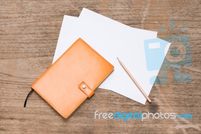 Orange Diary,blank Paper With Pencil On Wood Table Stock Photo