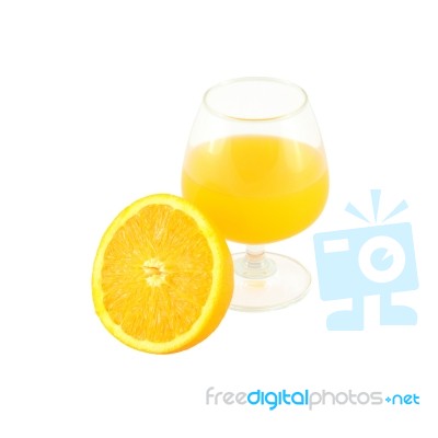 Orange Juice In Brandy Glass And Half Fruit On White Background Stock Photo