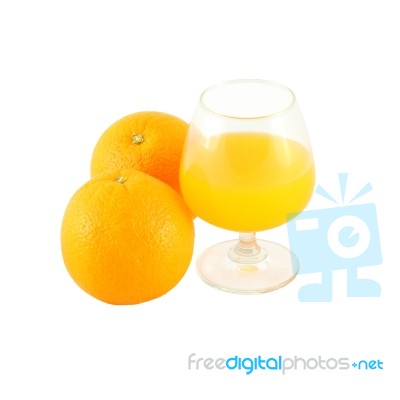 Orange Juice In Brandy Glass And Two Fruit On White Background Stock Photo