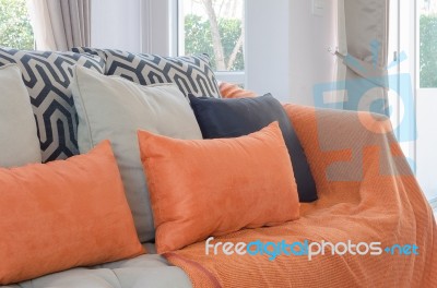 Orange Pillows And Blanket On Modern Sofa In Living Room Stock Photo