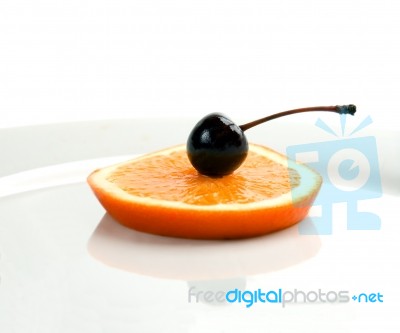 Orange&cherry On A Plate Stock Photo