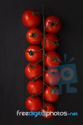 Organic Fresh Cherry Tomatoes On Black Board Background Stock Photo