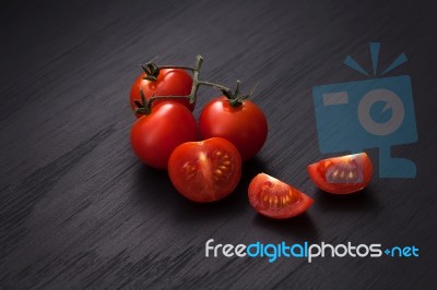 Organic Fresh Cherry Tomatoes On Black Board Background Stock Photo