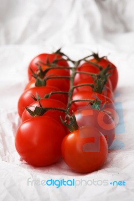 Organic Fresh Cherry Tomatoes On White Paper Background Stock Photo