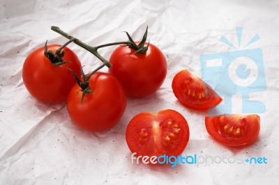 Organic Fresh Cherry Tomatoes On White Paper Background Stock Photo