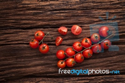 Organic Fresh Cherry Tomatoes On Wooden Background Stock Photo