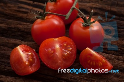 Organic Fresh Cherry Tomatoes On Wooden Background Stock Photo