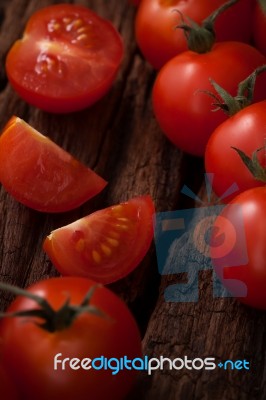 Organic Fresh Cherry Tomatoes On Wooden Background Stock Photo