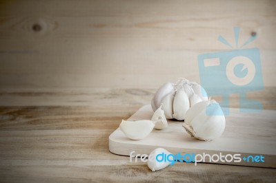 Organic Garlic Whole And Cloves On The Wooden Background Stock Photo