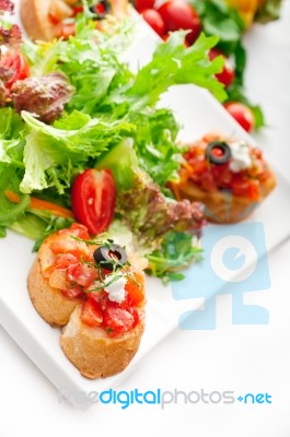 Original Italian Fresh Bruschetta Served With Fresh Salad And Ve… Stock Photo